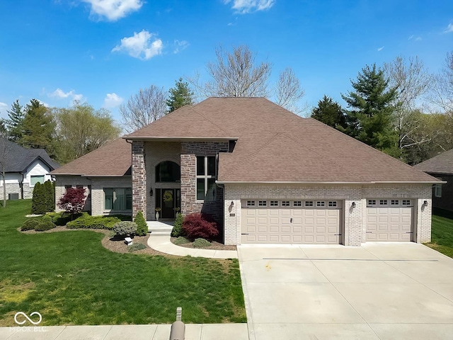 view of front facade with brick siding, driveway, a front yard, and a garage
