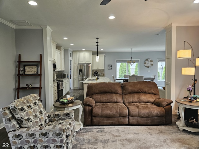 living area with crown molding, baseboards, and recessed lighting