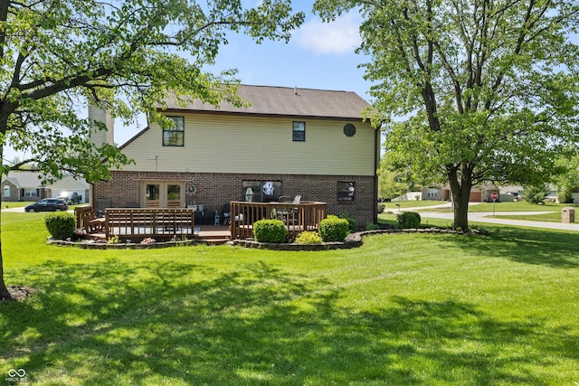 back of house with a lawn, brick siding, and a deck