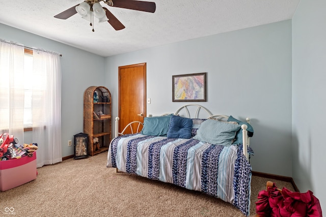 bedroom with carpet floors, a ceiling fan, a textured ceiling, and baseboards