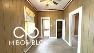 hall with ornamental molding and wood walls