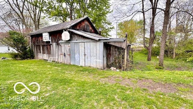 view of barn with a lawn