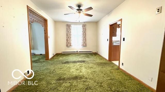 interior space with baseboards, carpet flooring, and baseboard heating