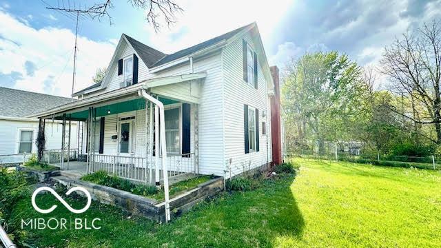 view of front of house with a porch and a front lawn