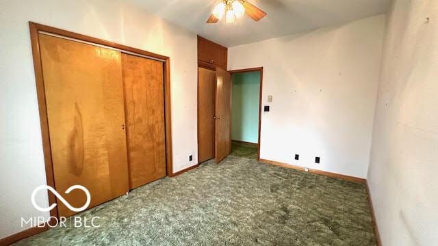 unfurnished bedroom with baseboards, ceiling fan, carpet, and a closet