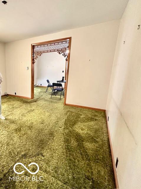 carpeted spare room with baseboards