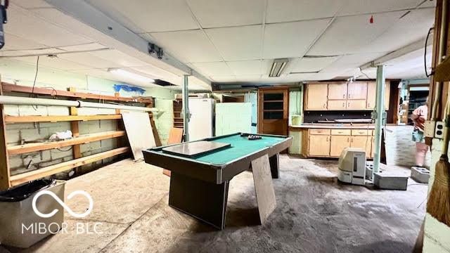 playroom featuring unfinished concrete floors, pool table, and a paneled ceiling