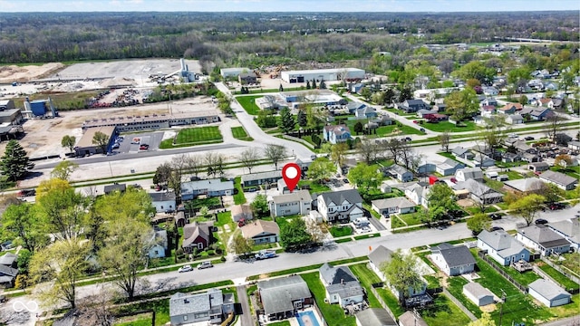 drone / aerial view featuring a residential view and a view of trees