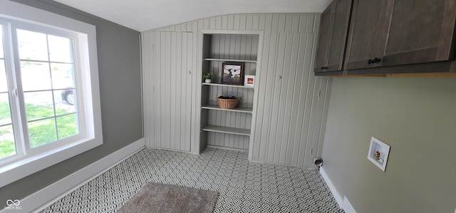 laundry room featuring baseboards, hookup for a washing machine, and cabinet space