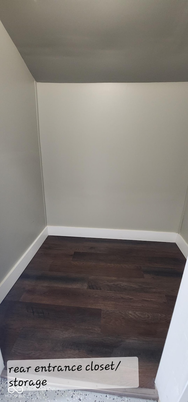 interior space with dark wood-type flooring and baseboards