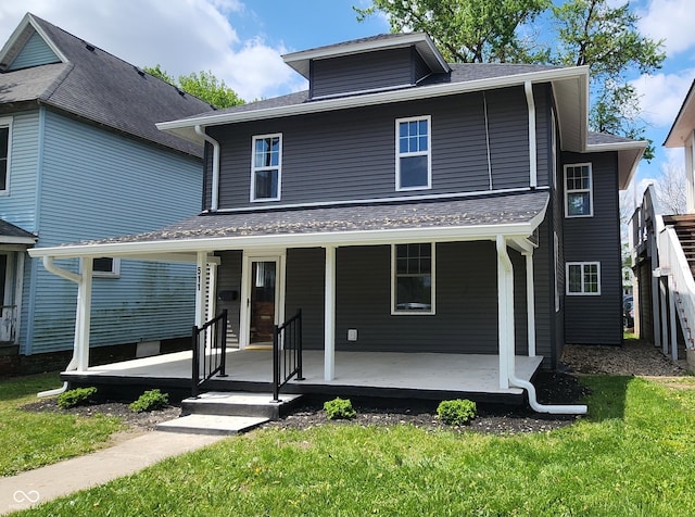 traditional style home featuring a porch and a front yard