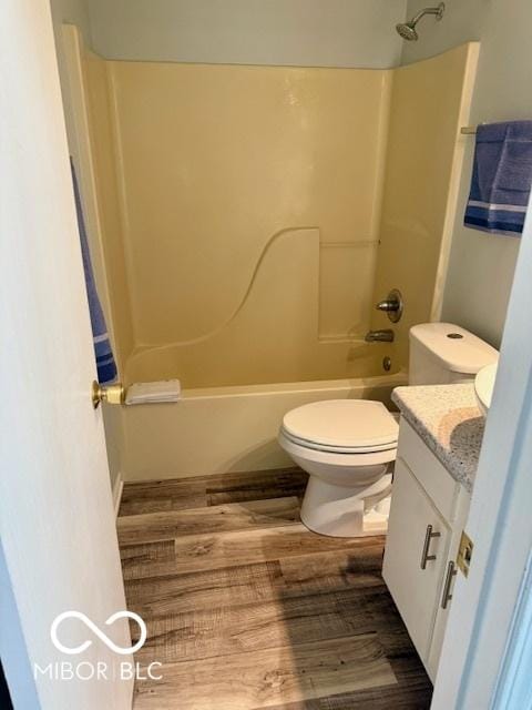 full bathroom featuring shower / bathtub combination, toilet, wood finished floors, and vanity