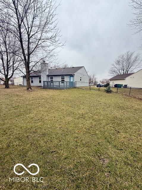 view of yard with fence and a wooden deck