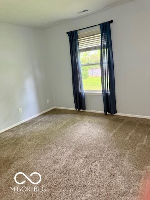 carpeted empty room with baseboards and visible vents