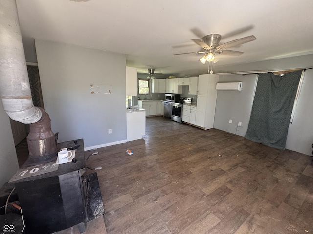 unfurnished living room featuring a ceiling fan, a wall mounted AC, dark wood-style floors, and a wood stove