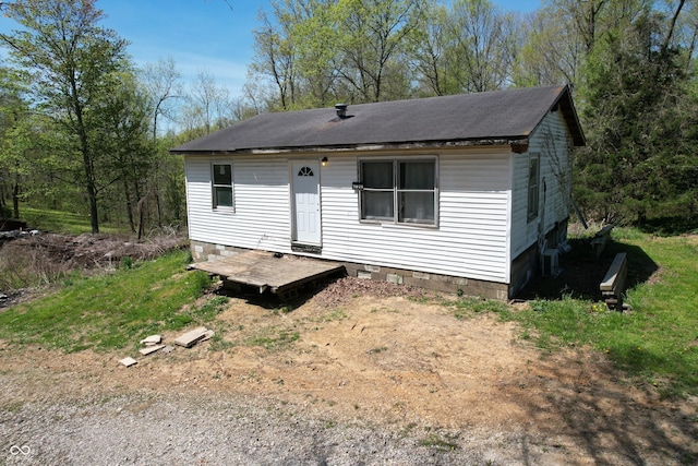 rear view of house with a shingled roof