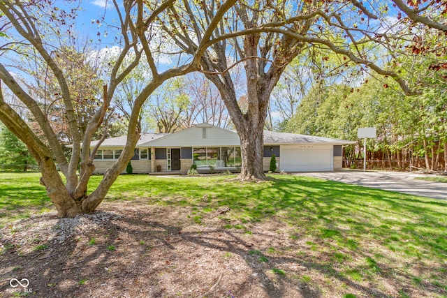ranch-style home with fence, concrete driveway, a front yard, and a garage