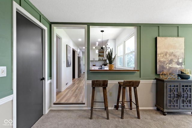 interior space featuring an inviting chandelier and carpet floors