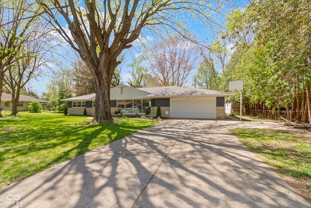 ranch-style home featuring a front lawn, driveway, and a garage