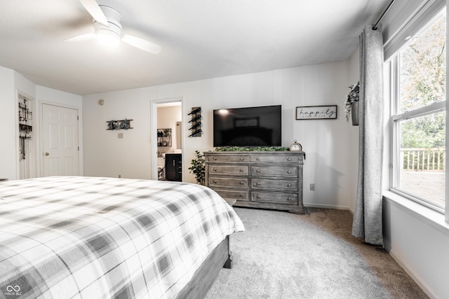 bedroom featuring carpet floors, ceiling fan, baseboards, and ensuite bath