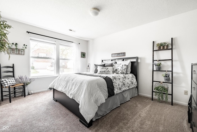 carpeted bedroom featuring baseboards, a textured ceiling, and visible vents