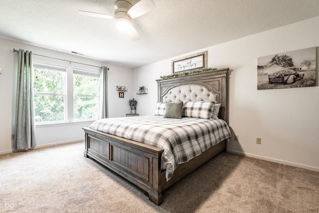 bedroom featuring baseboards, light colored carpet, a textured ceiling, and visible vents
