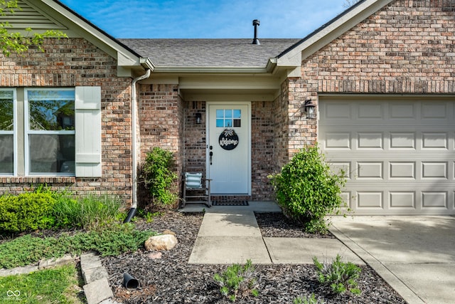 view of exterior entry featuring brick siding, roof with shingles, and a garage