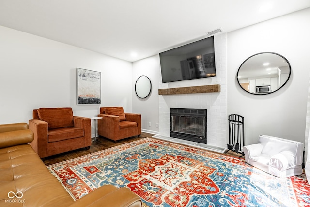 living area featuring wood finished floors, a fireplace, and recessed lighting