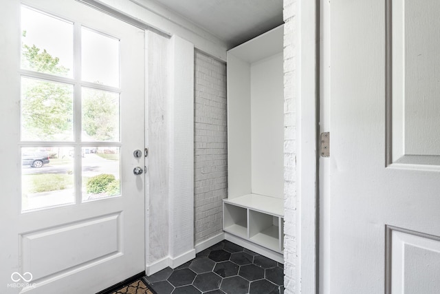 mudroom featuring dark tile patterned flooring
