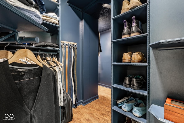 walk in closet featuring wood finished floors