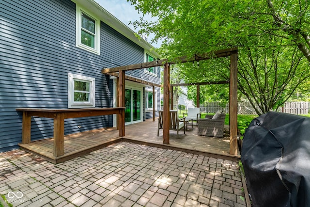 deck with a fenced backyard and a grill