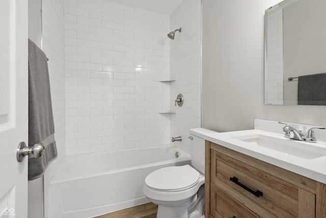 full bath featuring toilet, wood finished floors, vanity, and  shower combination