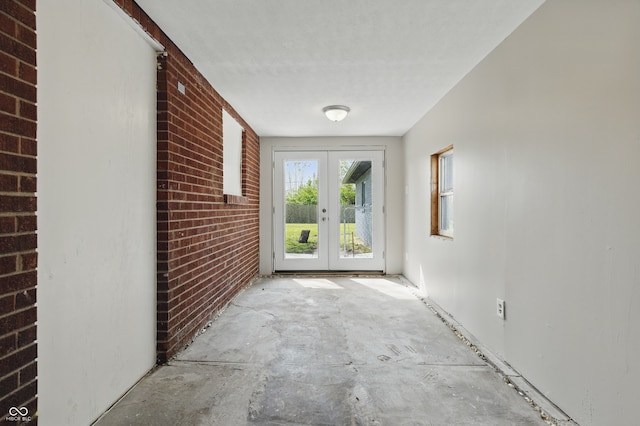 doorway featuring french doors and brick wall