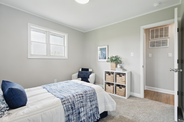 bedroom featuring carpet flooring, baseboards, and crown molding