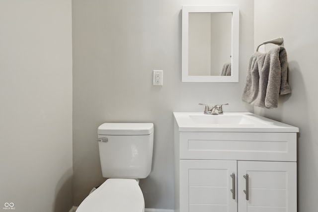half bathroom with toilet and vanity