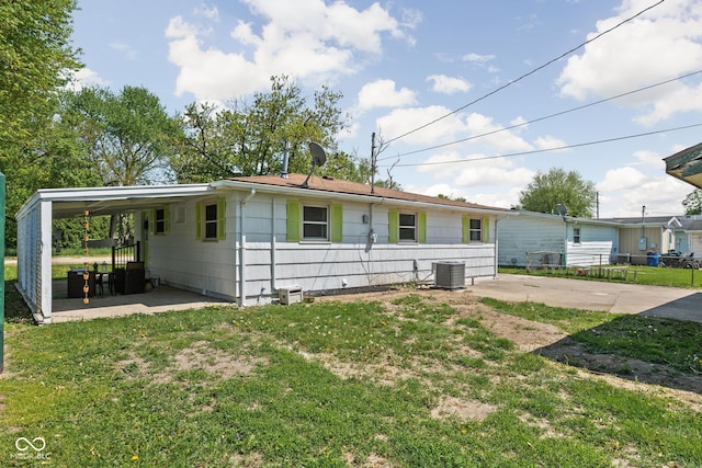 view of front of home featuring central air condition unit, a carport, and a patio