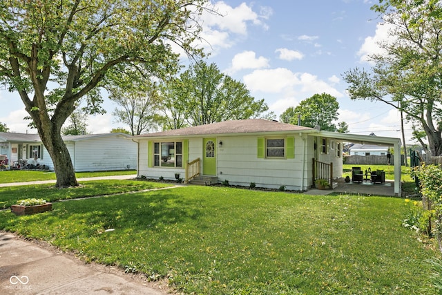 single story home with entry steps, a front lawn, and a carport