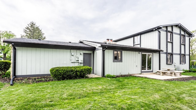 back of property with a patio and a yard