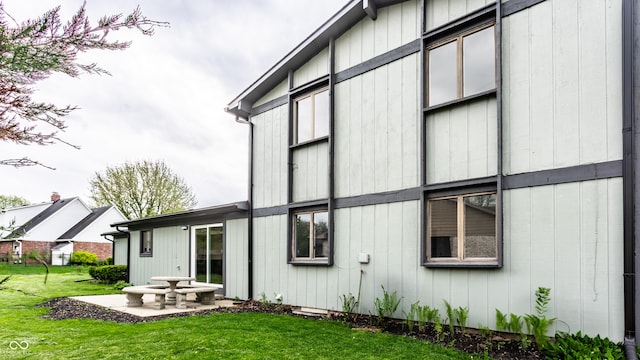 rear view of property with a lawn