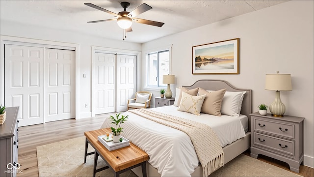 660 Sun Valley Ct, Indianapolis, IN 46217 - bedroom featuring two closets, light wood finished floors, and ceiling fan