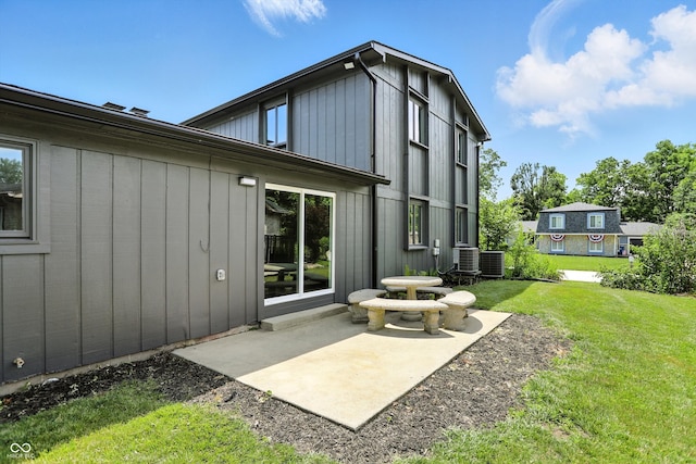 660 Sun Valley Ct, Indianapolis, IN 46217 - rear view of house featuring a patio, a yard, and board and batten siding