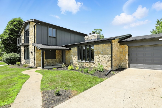 660 Sun Valley Ct, Indianapolis, IN 46217 - mid-century modern home with stone siding, a garage, driveway, and a chimney
