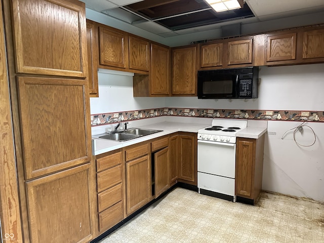 10770 W 650 S, Columbus, IN 47201 - kitchen featuring brown cabinetry, black microwave, light floors, white electric range, and a sink