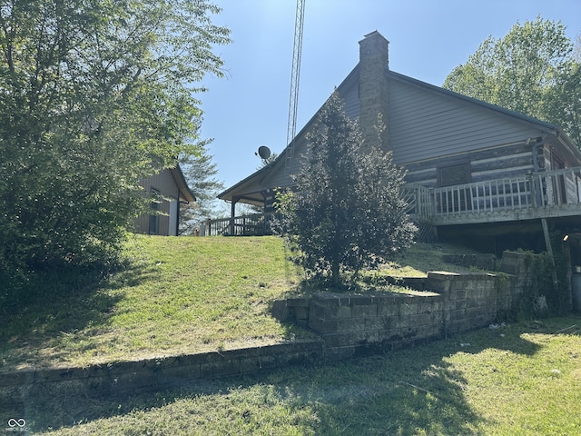 10770 W 650 S, Columbus, IN 47201 - view of side of property featuring a lawn, a chimney, and a wooden deck