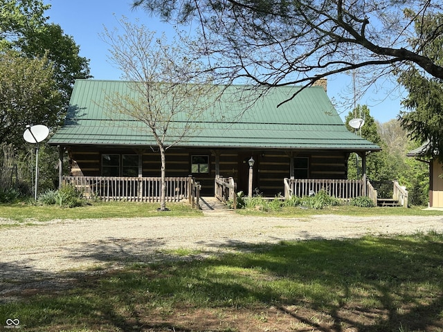 10770 W 650 S, Columbus, IN 47201 - cabin with covered porch, log siding, a chimney, a standing seam roof, and metal roof