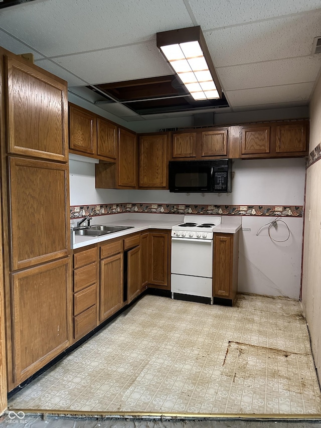 10770 W 650 S, Columbus, IN 47201 - kitchen featuring black microwave, brown cabinets, a sink, light floors, and white electric range oven