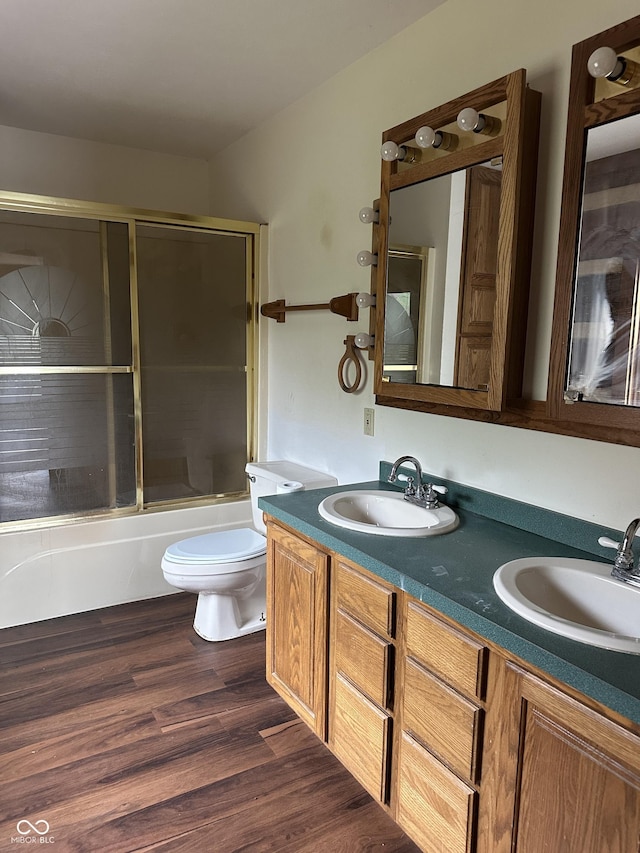 10770 W 650 S, Columbus, IN 47201 - bathroom with double vanity, a sink, bath / shower combo with glass door, and toilet