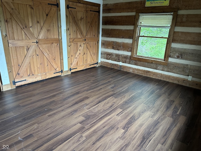 10770 W 650 S, Columbus, IN 47201 - empty room with a barn door and dark wood-style flooring