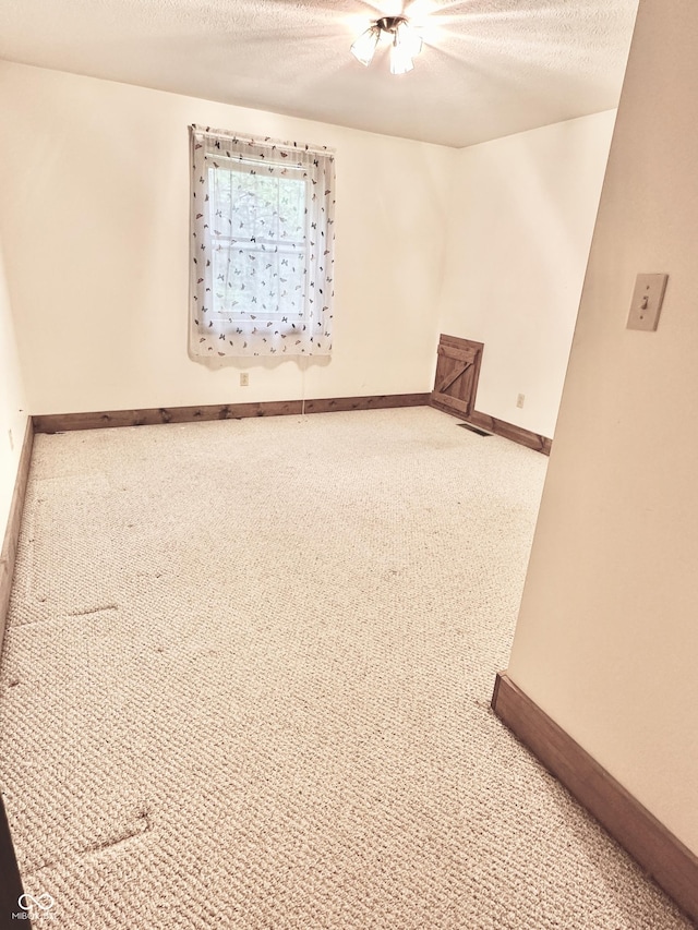 10770 W 650 S, Columbus, IN 47201 - carpeted spare room featuring baseboards, a textured ceiling, and visible vents