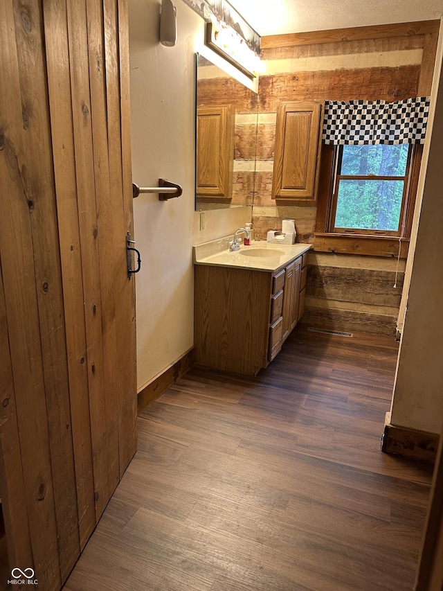 10770 W 650 S, Columbus, IN 47201 - bathroom featuring a sink, baseboards, double vanity, and wood finished floors